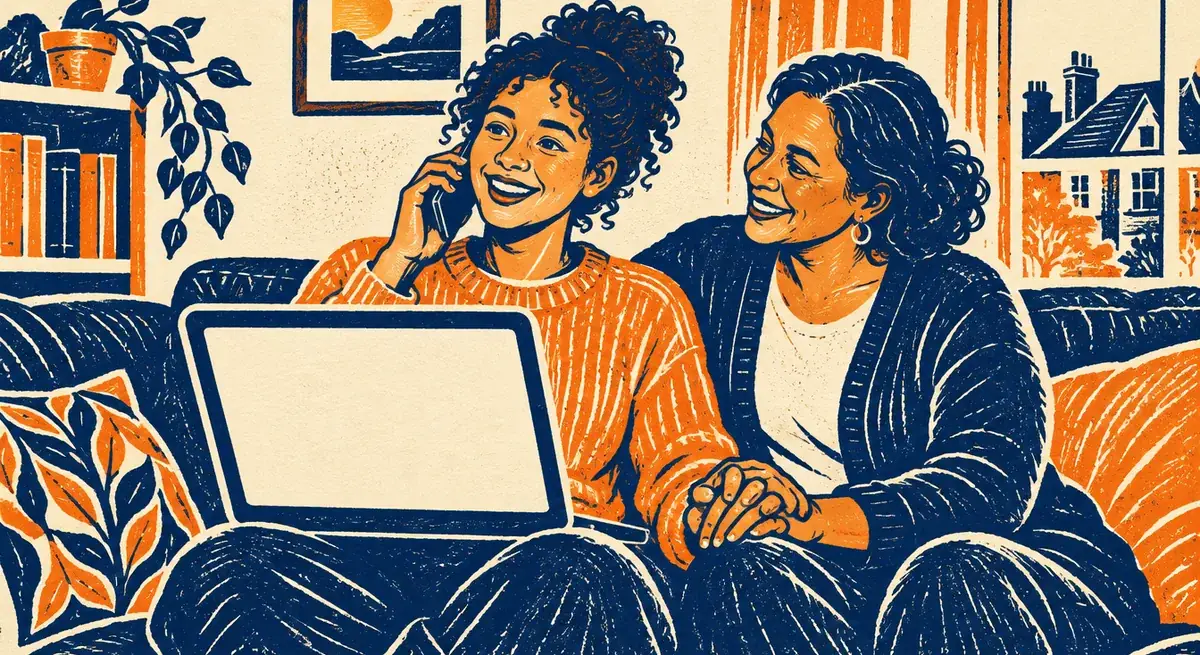A student on the phone beside a laptop, sitting on a sofa with a smiling parent holding her hand